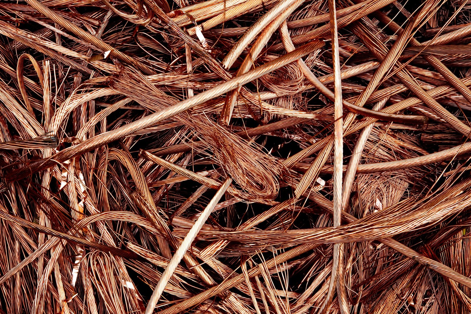 Close-up view of intertwined copper wires ready for recycling, emphasizing industrial reuse.